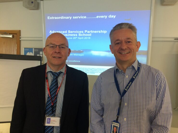 Two attendees from Rolls Royce smile and pose for a photograph at the Partnership roundtable hosted by ASG in 2018