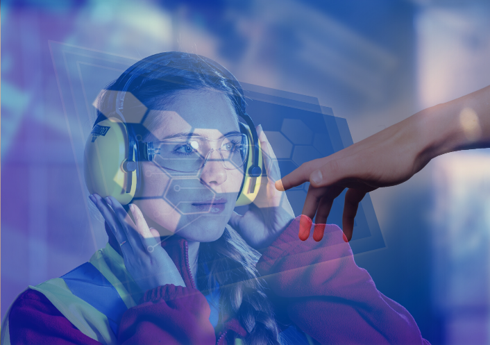A female factory worker wears ear defenders. A hand reaches toward her.
