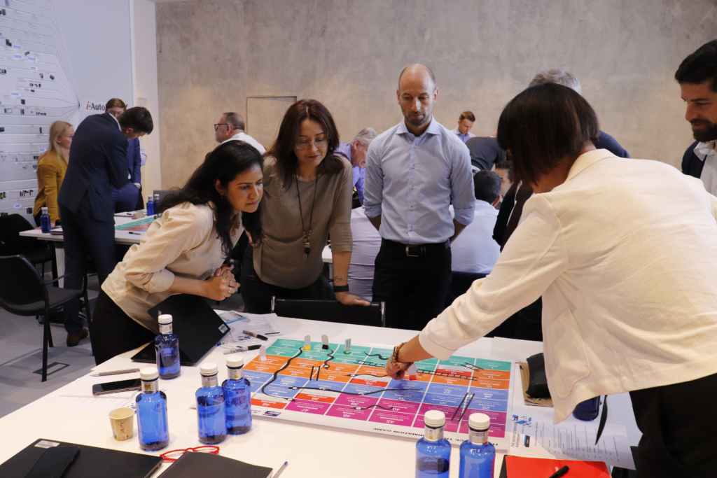 Colleagues collaborate over a large ASG worksheet at an ASG event