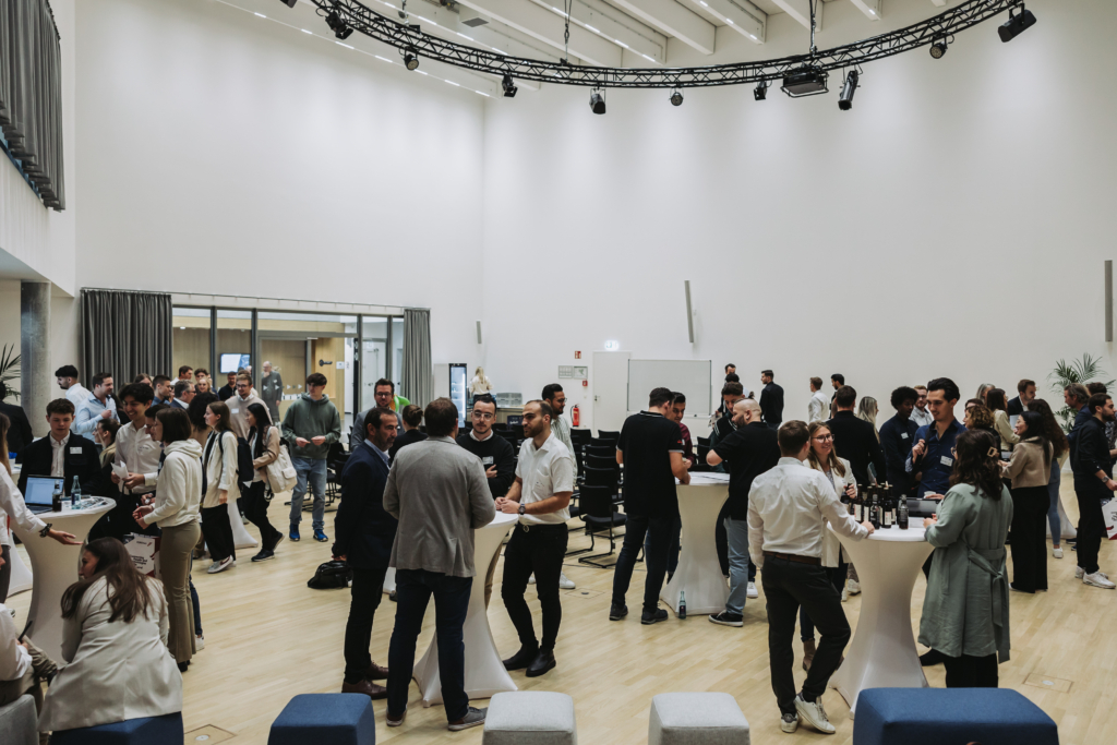 A collection of professional people socialising in an event space