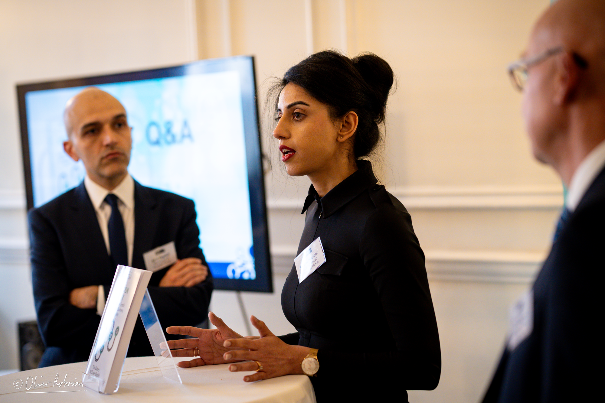 Dr Kawal Kapoor answers a question in a Q and A, and is listened to by her colleagues