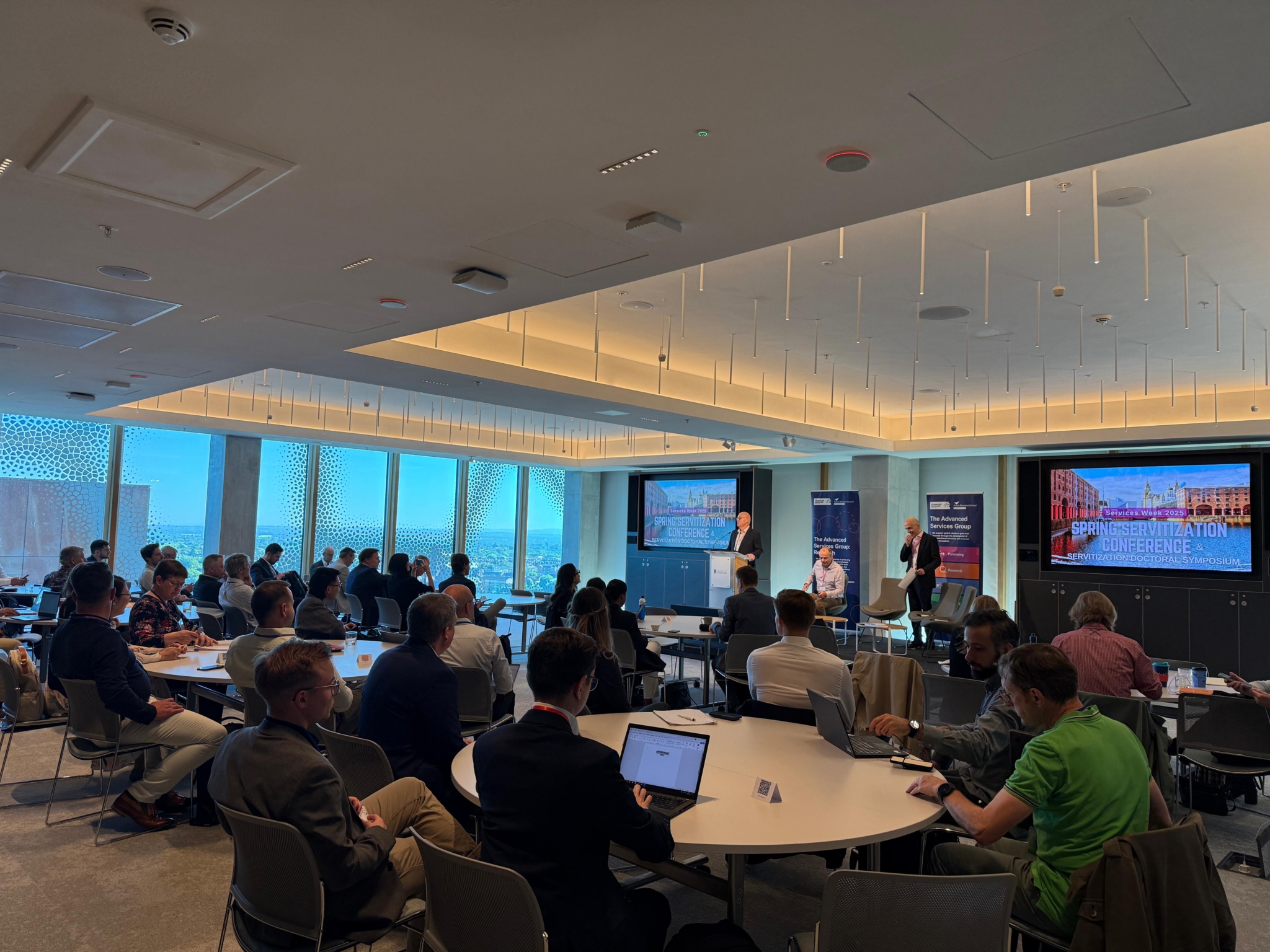 Attendees listen intently to a speaker at the spirng servitization conference